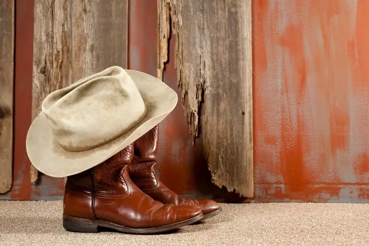 red cowboy boots with stain hat