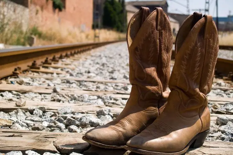 A pairs of cowboy boots under the hot sun