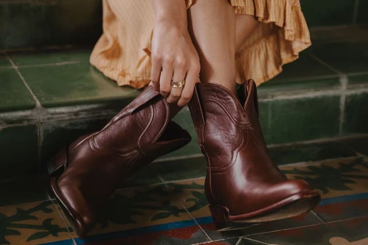 a girl is wearing a long dress with The Penny goat boots of Tecovas