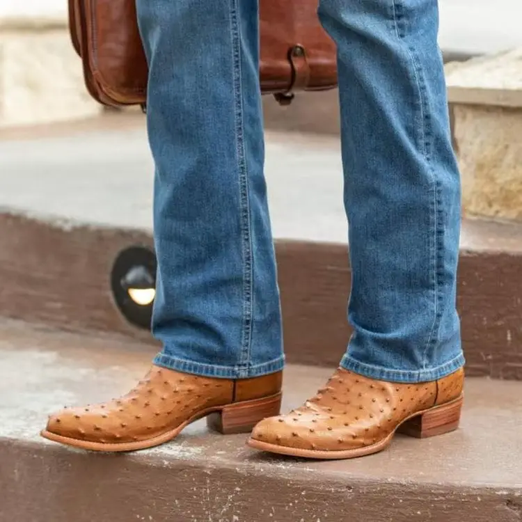 man carrying the handbag wears The Wyatt boots from Tecovas