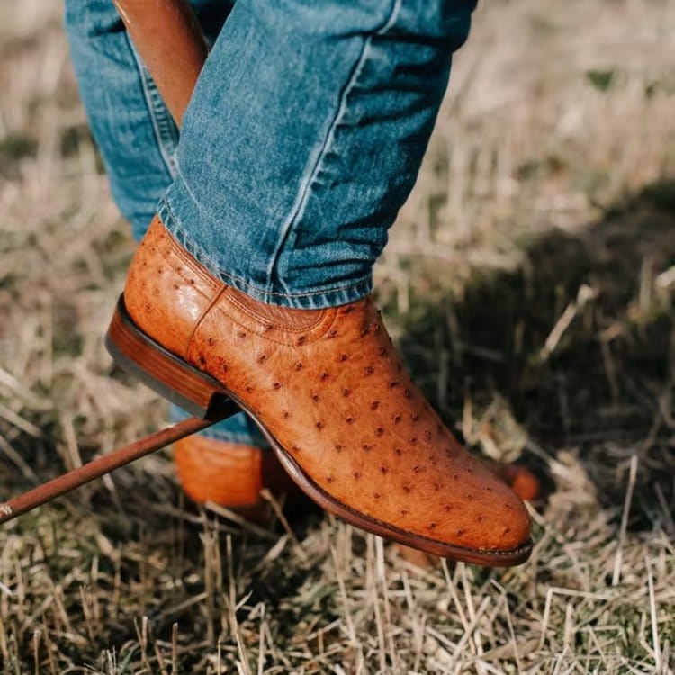 The Duke ostrich cowboy boots from Tecovas worn with jeans