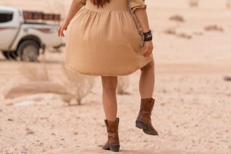 A girl is running with her cowboy boots