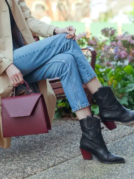 A woman wears black cowboy boots with jeans, jacket for dressy casual