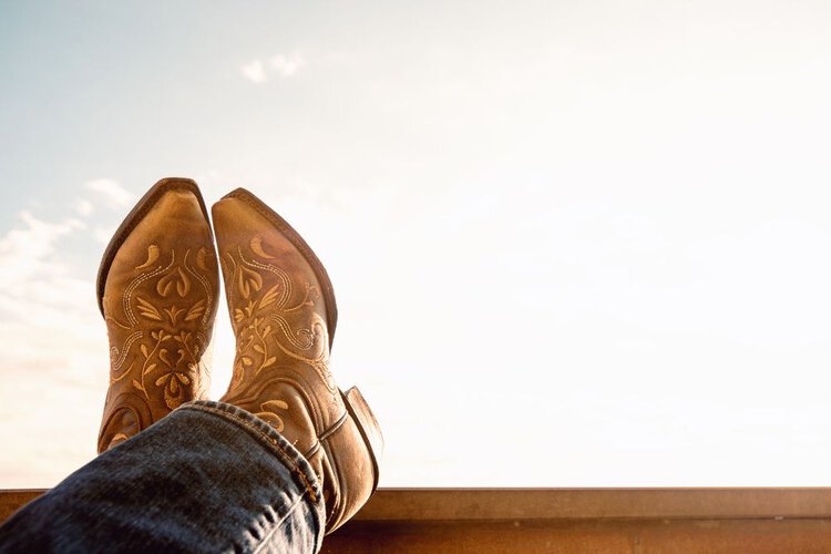 Cowboy boots with many stitching