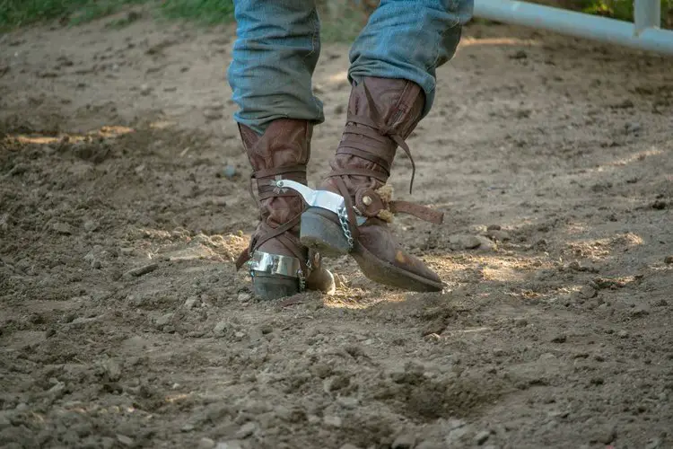 Man wear cowboy boots on the ranch