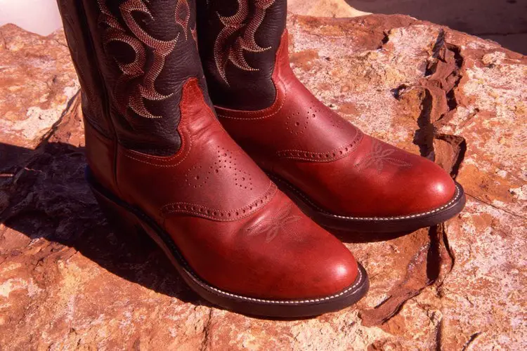 a pair of cowboy boots on concrete floor