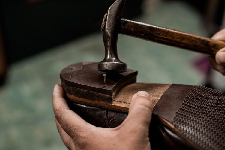 Cobbler reparing the heel