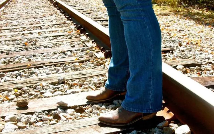 Women wear bootcut jeans with cowboy boots