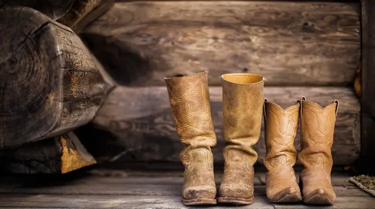 two pair of cowboy boots on the wooden floor