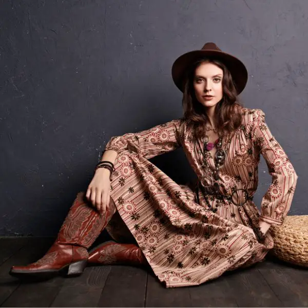 a woman wears a boho fancy dress with cowboy boots