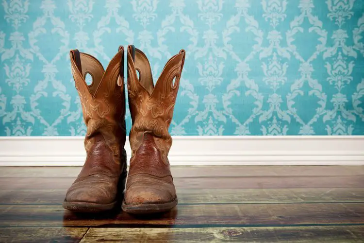 A pair of cowboy boots on the floor