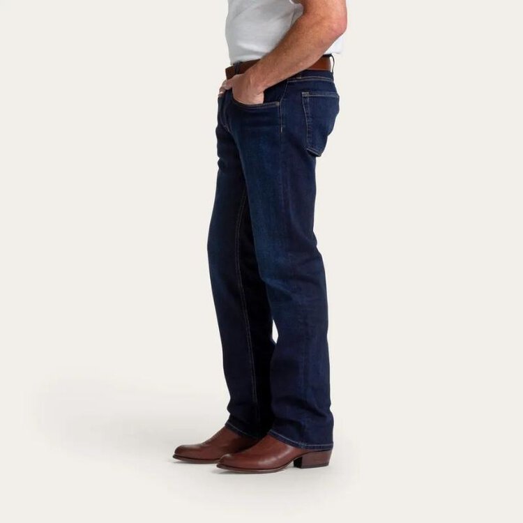 Man wear cowboy boots, T shirt and jeans