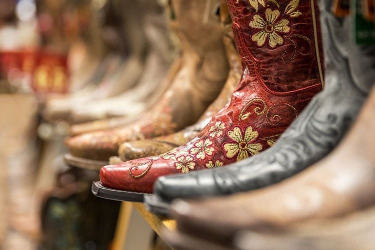 Many pairs of new cowboy boots in the store