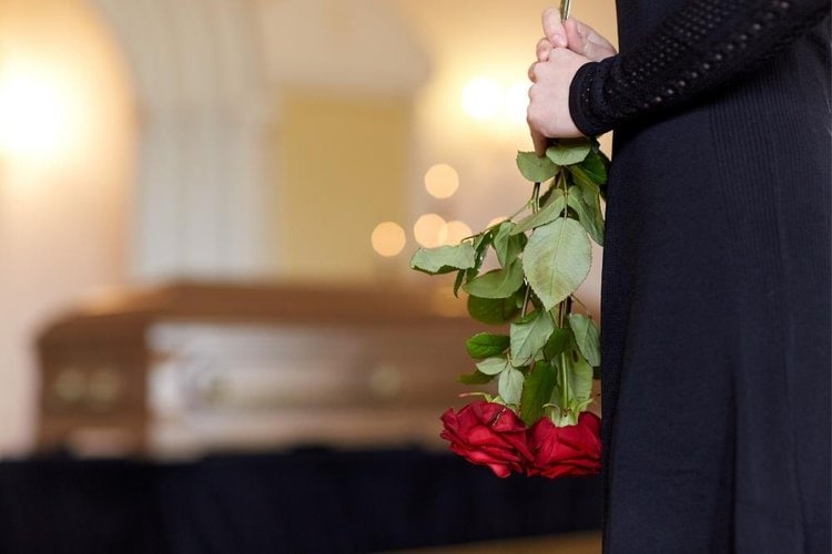 a lady with black dress in a funeral