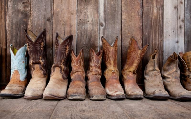 Many pairs of cowboy boots on the floor (2)