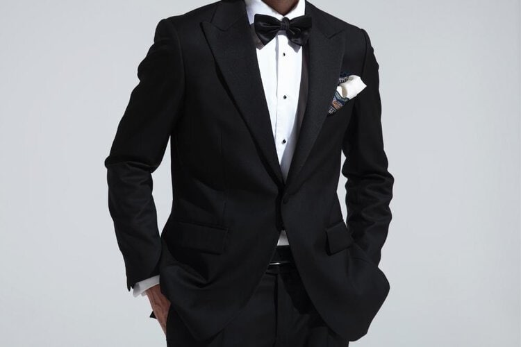 a man wears black tuxedo