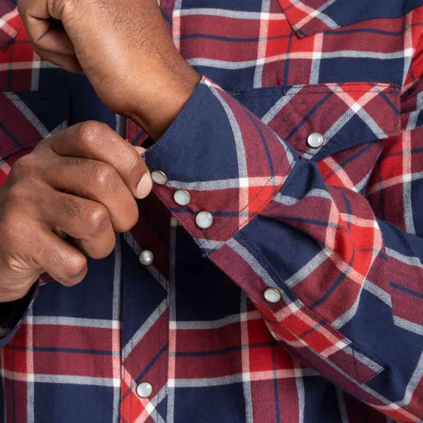 Man fastening the cuff of pearl snap shirts