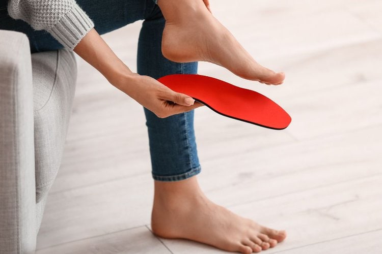 a girl tries an insole