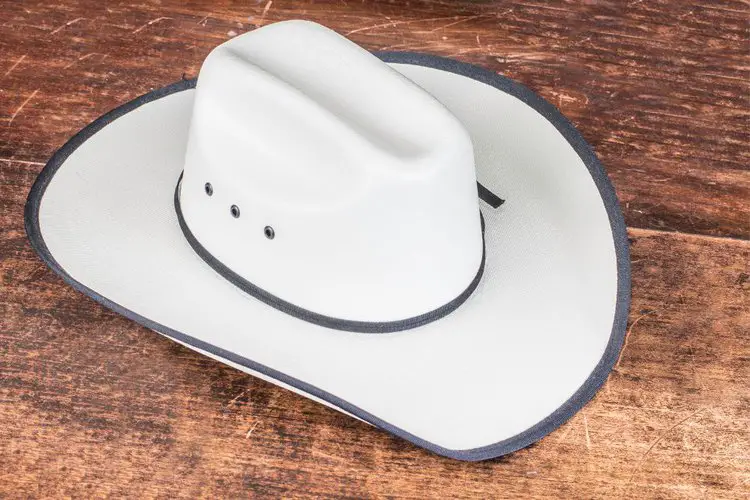 a white cowboy hat metal holes on the side