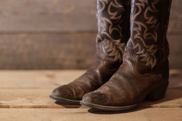 dry cowboy boots on the wooden floor