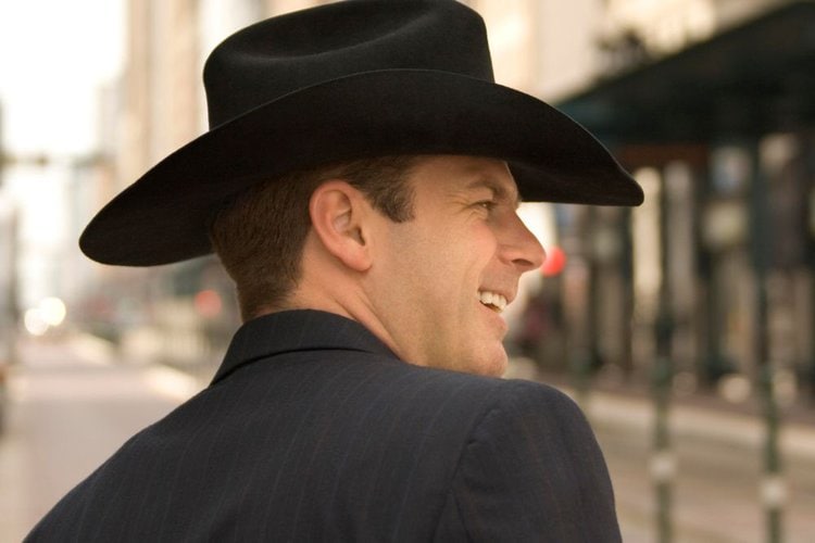 man looks so cool in cowboy hat and black suit