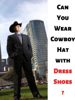 man wears cowboy hat with dress shoes and stands in apartment buildings