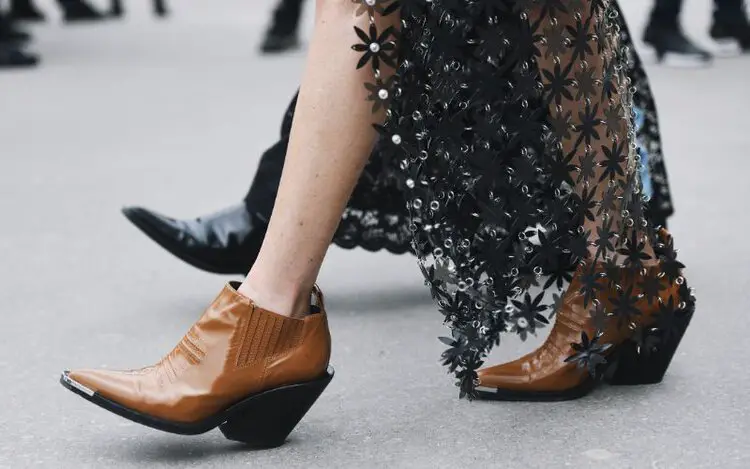 A woman wears maxi skirt with cowboy boots