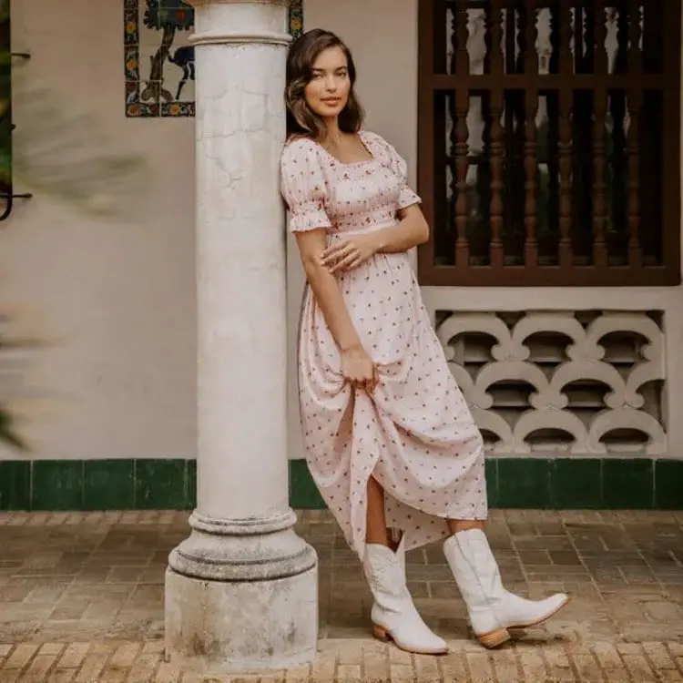 Woman wears maxi dress with a pair of The Chloe cowboy boots