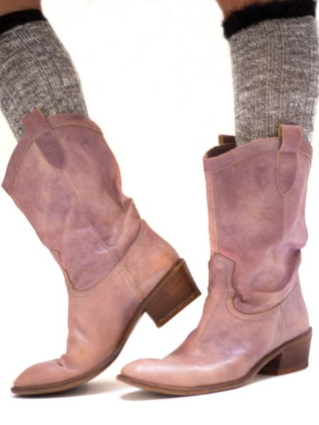 A woman wears boot socks and cowboy boots