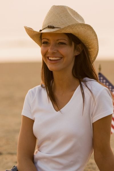 A woman wears a cowboy hat