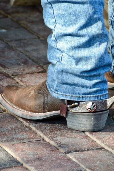 A man wear cowboy boots with bootcut jeans