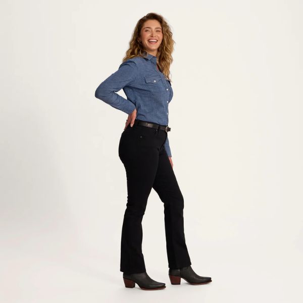 A woman wears double Tecovas denim with different shade.