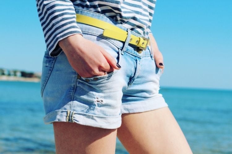 A woman wears shorts denim with wide open legs