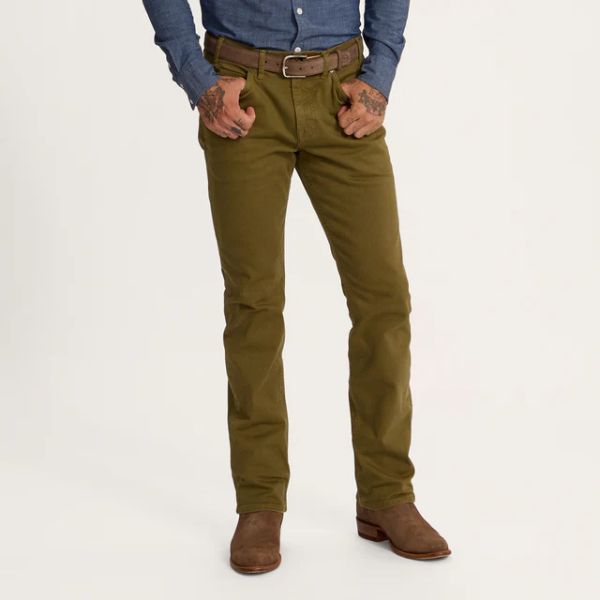 A man wears Men's Everyday Standard Jeans in olive color