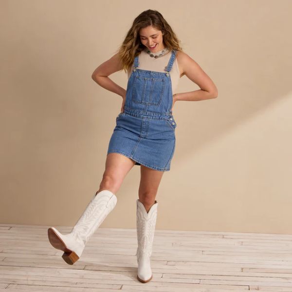A woman wears The Abby White Cowboy Boots