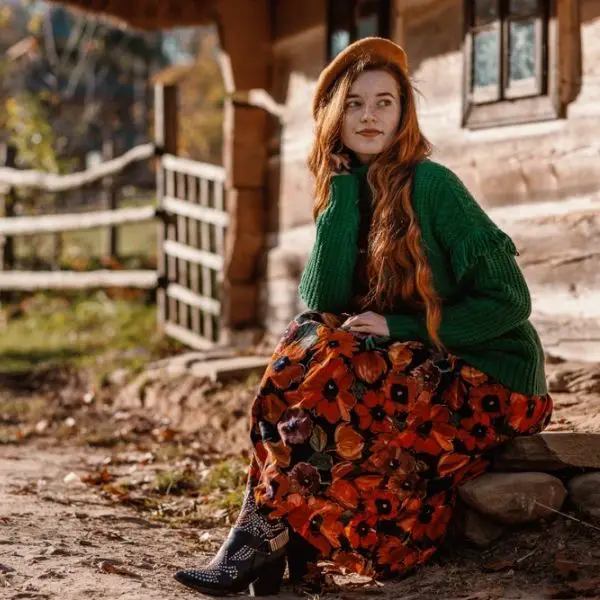 A woman wears boho dress with black cowboy boots