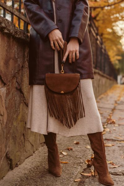 A woman wears wool midi dress with a leather blazer