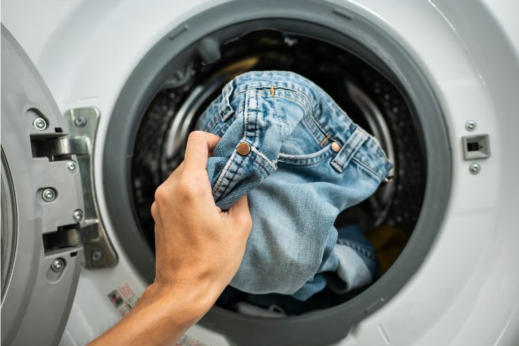 Put jeans into washing machine