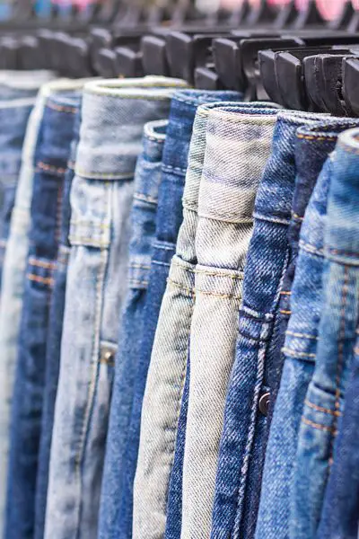 many pairs of jeans on the wardrobe