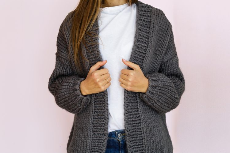 A woman wears cardigan and sweater