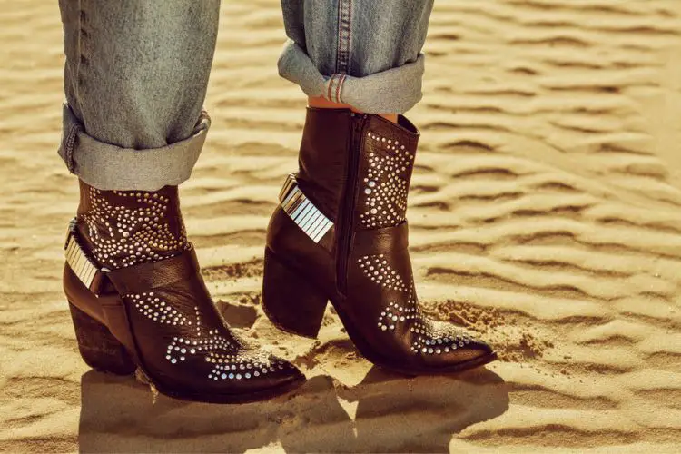 A woman wears cowboy boots with pointed toe and high heel