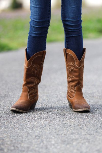 A woman wears round to boots with standard heel height