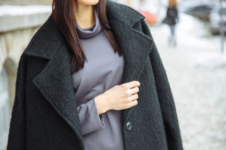 A woman wears wool trench coat