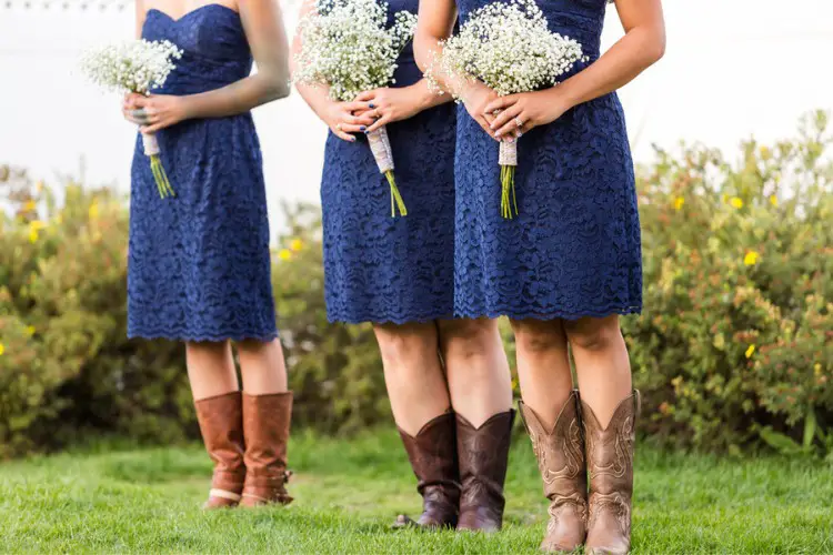 Bridesmaids wear lace dresses and cowboy boots at weddings