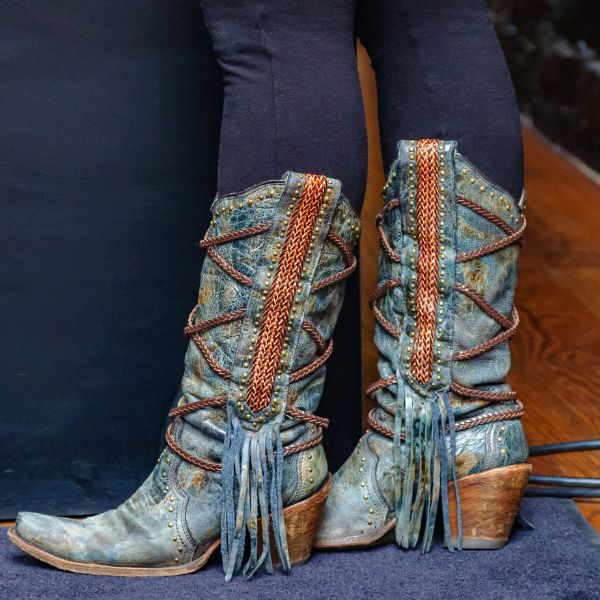 Stylish cowboy boots with fringe around