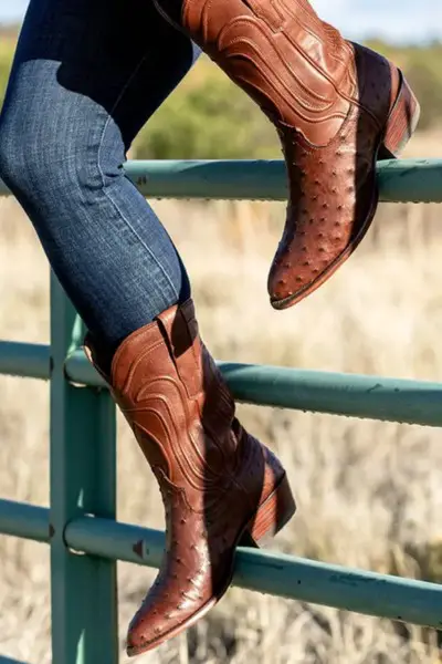 A woman wears The Jessie cowboy boots with jeans