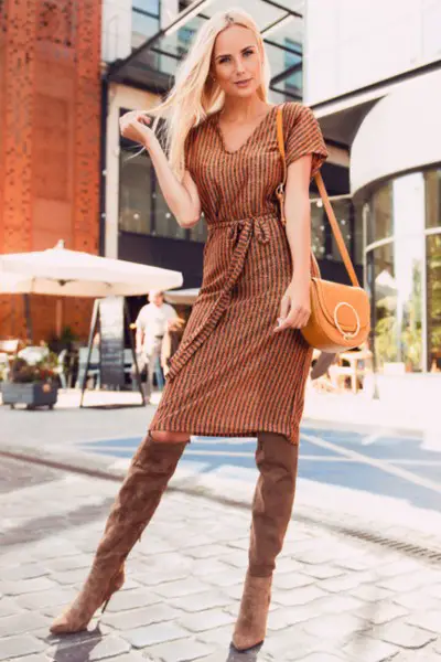 A woman wears dress with cowboy boots