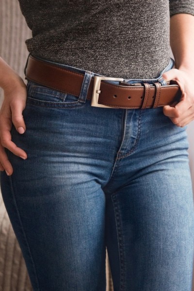 A woman wears jeans with belt