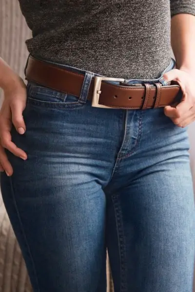 A woman wears jeans with belt