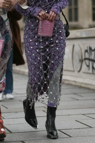 A woman wears pointed toe cowboy boots with dresses